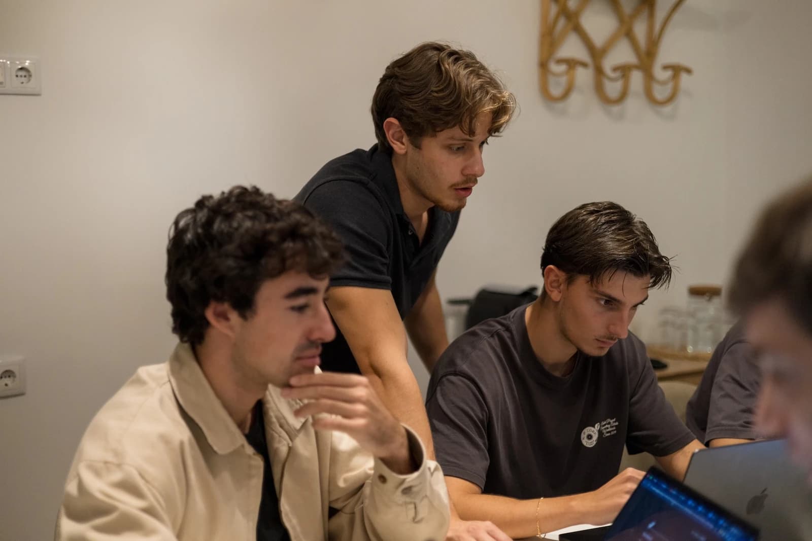 TensorOps colleagues gathered around laptops